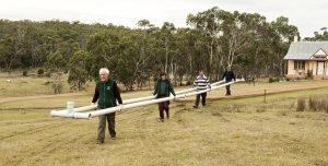 Bruce, Anne, Peter and Richard joyfully carrying drainage pipes to their new home.