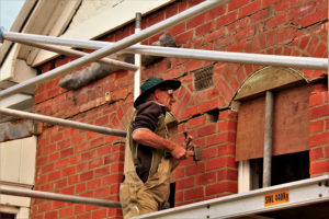 Vollunteer bricklayer repairs the fabric of Quarters No 3